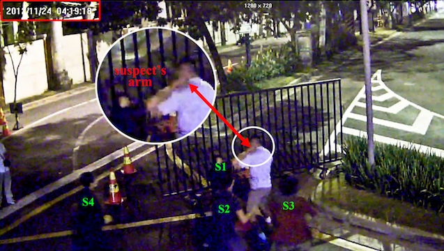 STABBED IN THE NECK. This is the exact moment when one of the 4 suspects brings his hand close the victim's neck. The victim is already bleeding in the next fragment of the CCTV video. Photo from case file