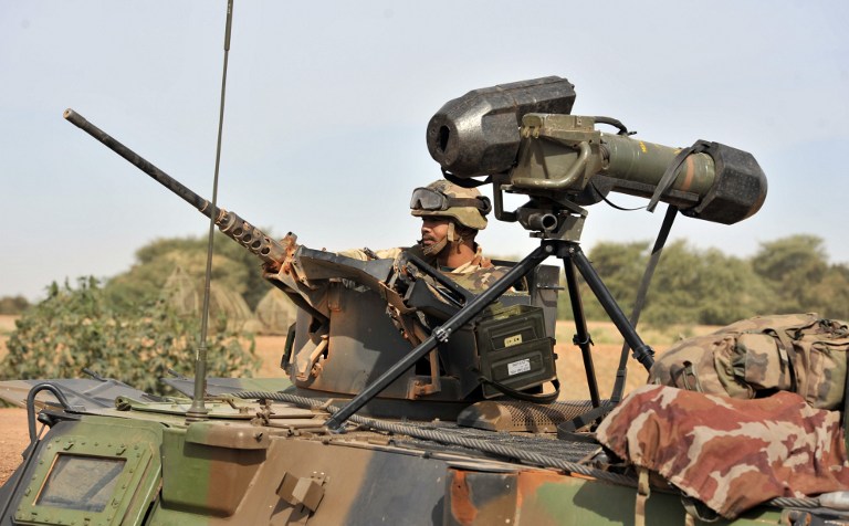 A French soldier deployed near city of Diabaly keeps post from a machine gun mounted vehicle on January 22, 2013. AFP PHOTO / ISSOUF SANOGO