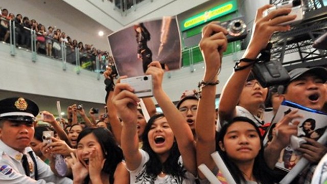 BEYOND SHOPPING. Malls now offer the 'total experience' rather than just shopping to Filipinos. This photo shows screaming fans in a mall concert of a popular foreign artist. Photo courtesy of AFP.