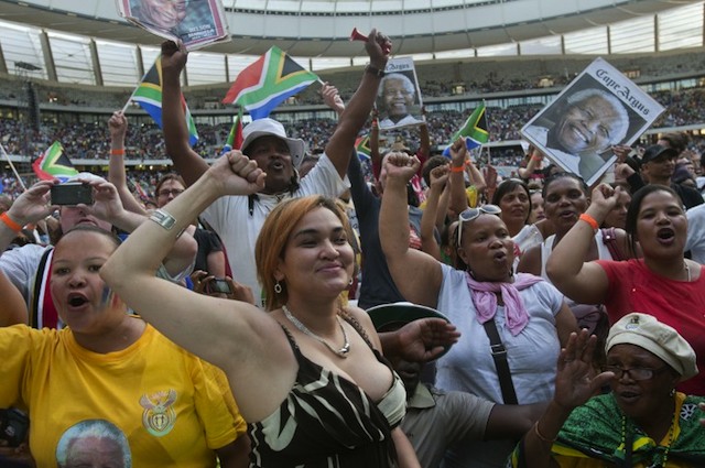 CELEBRATING MADIBA. People cheer during the Nelson Mandela tribute concert called "A life celebrated" at Cape Town Stadium on December 11, 2013 in Cape Town. AFP/Rodger Bosch