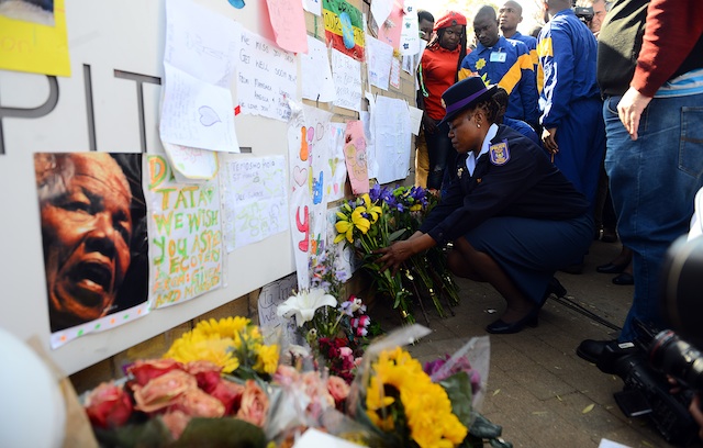 FOR MADIBA. South African Police Services trainees bring flowers and messages of support at the entrance to the Medi-Clinic Heart Hospital in Pretoria, Gauteng, South Africa, 25 June 2013 where former president Nelson Mandela is believed to be undergoing treatment for a recurring lung infection. EPA/STRINGER