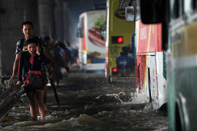 WADING THROUGH TAFT AVENUE. Photo by AFP/Ted Aljibe