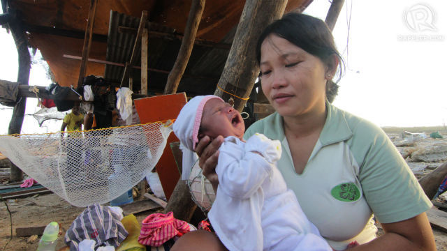 YOLANDA SURVIVOR. Like Mary in the Gospels, Maricel Jerusalem nurses her two-week-old baby in the worst of conditions after Super Typhoon Yolanda swept away their home. File photo by Franz Lopez