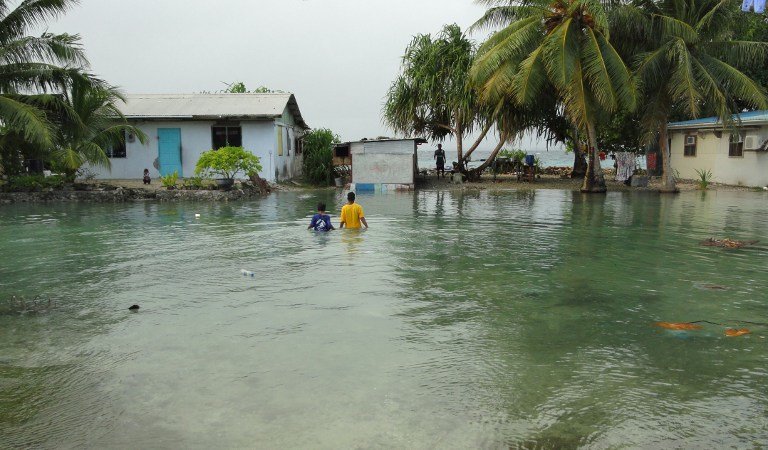HIGH TIDE FLOOD. In this file photo, local residents wade through flooding caused by high ocean tides in low-lying parts of Majuro Atoll, the capital of the Marshall Islands, on February 20, 2011. Photo by AFP / Giff Johnson