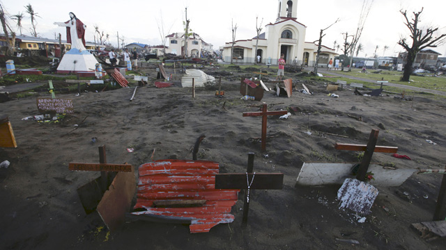 MASS BURIAL. A view of a mass grave outside a Catholic church in the super typhoon-devastated city of Palo, Leyte province, Philippines. Photo by Dennis M. Sabangan/EPA