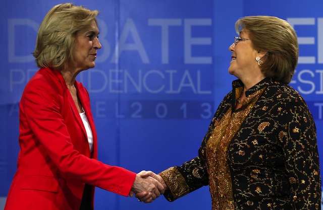 FACE OFF. The presidential candidates of Chile Michell Bachelet (R) and Evelyn Matthei (L) shake hands before the beginning of the televised debate in Santiago de Chile, Chile, 10 December 2013. EPA/Felipe Trueba