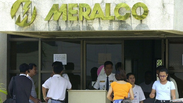 People arrive at the office of Meralco, the country's largest power distributor, to make payments. AFP PHOTO/JAY DIRECTO