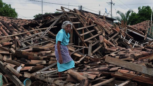 MANUEL'S DESTRUCTION. An old woman resident of a rural zone of Acapulco called Agua Caliente walks amid the rubble of of her home, in Guerrero state, Mexico on September 20, 2013. AFP/Claudio Vargas