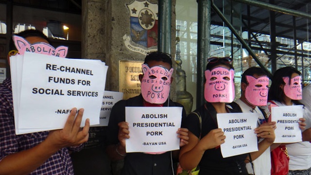 NEW YORK PROTEST. Filipino-American activists wearing masks of pigs stage a protest in front of the Philippine consulate on 5th Avenue in New York City to protest against the corruption of pork barrel back in the Philippines. Photo by Cristina DC Pastor