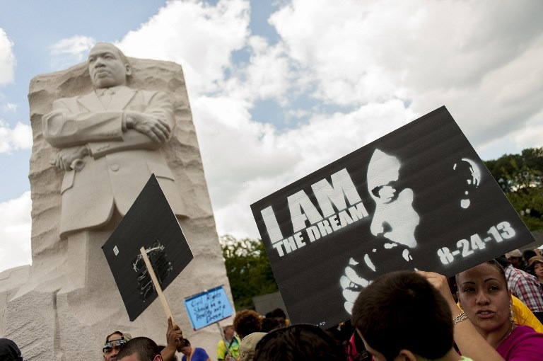 'I AM THE DREAM.' People arrive at the National Mall to celebrate the 50th anniversary of the March on Washington and Dr. Martin Luther King, Jr.'s 'I have a Dream' speech, August 24, 2013 in Washington, DC. Pete Marovich/Getty Images/AFP