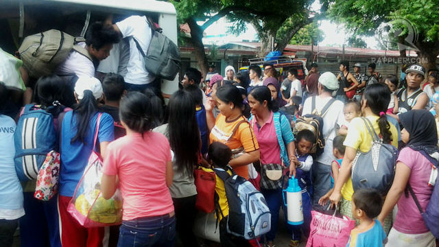 HUMANITARIAN CONCERNS. Evacuees rush to a government vehicle as they flee their village. Photo by Richard Falcatan/ Rappler