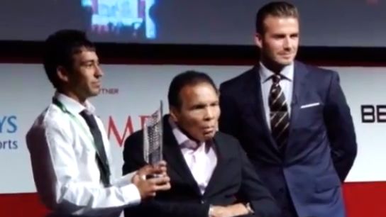 MUHAMMAD ALI WITH DAVID Beckham when they presented an inaugural award to a young Afghan refugee in London on July 24. Screen grab from YouTube (telegraphtv)