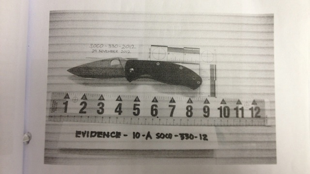MURDER WEAPON. One or more of the defendants stabbed the victim with this bloodstained tactical knife recovered from inside the Volvo. Photo from case file