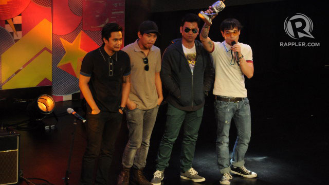 FAVORITE GROUP. Callalily proudly raise their trophy
