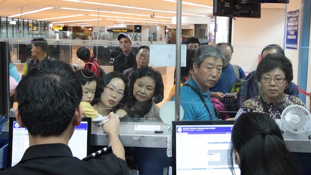 NO STAMP. Chinese visitors line up at immigration booths at Ninoy Aquino International Airport in Manila. Photo by Jedwin Llobrera