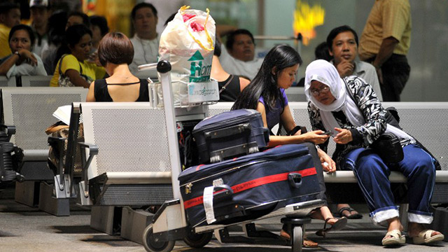 WAITING. Passengers wait for their flight in the Ninoy Aquino International Airport. File Photo by AFP