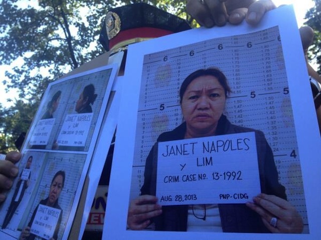 MUGSHOTS: Police officers show the media mugshots of Janet Lim Napoles. Photo by Paterno Esmaquel/Rappler