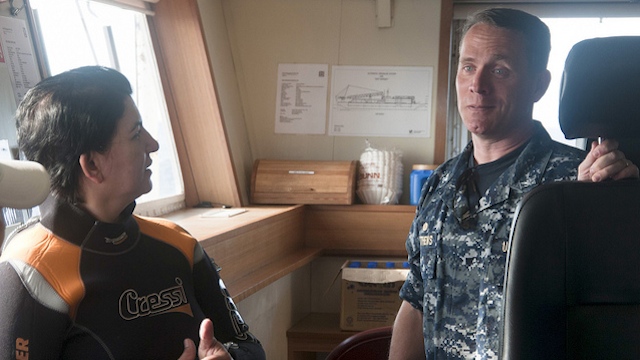 PH, US COOPERATION. US Navy supervisor of salvage Capt Mark Matthews (R), on-scene commander for the salvage of the USS Guardian, speaks with park superintendent Angelique Songco aboard the SMIT Borneo. Photo courtesy of US Navy