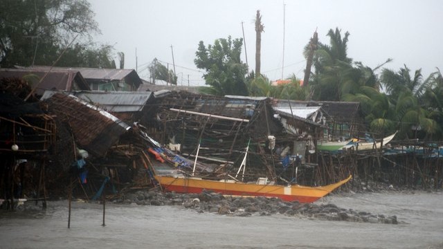 CALAMITY. Storm surges destroy boats and houses in coastal Brgy. Tuburan in EB Magalona, Negros Occidental. Photo by Gilbert Bayoran