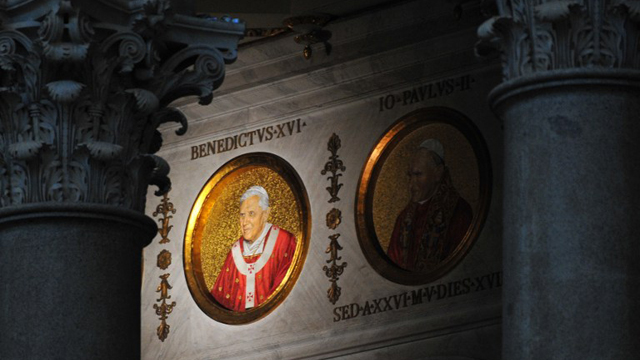 POPE'S PORTRAIT. The portrait of Pope Benedict XVI is displayed on a wall of the St Paul Outside the Walls’ basilica on February 13, 2013 in Rome. AFP PHOTO / TIZIANA FABI