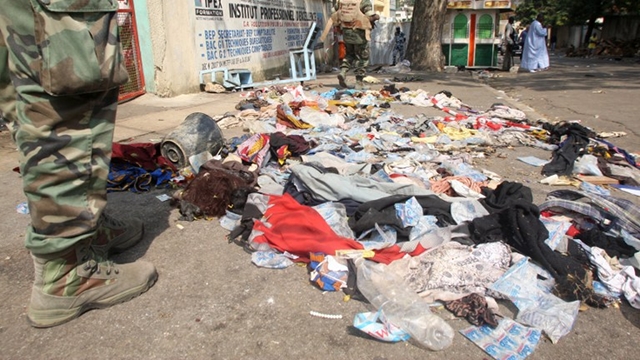 NEW YEAR ACCIDENT. UN peacekeepers stand on a street in Abidjan as shoes and various items are seen on the pavement at the scene of a stampede, on January 1, 2013. At least 60 people died and at least dozens were injured as crowds stampeded overnight during celebratory New Year's fireworks, Ivory Coast rescue workers said on January 1, 2013. AFP PHOTO/HERVE SEVI