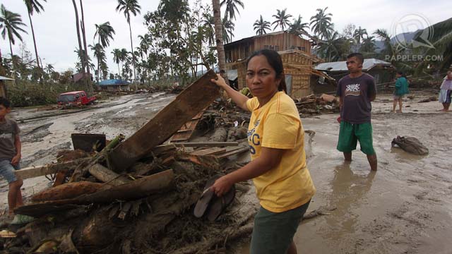 DAMAGE. A resident of New Bataan, Compostela Valley tries to salvage scrap wood from debris caused by typhoon Pablo (Bopha), December 5, 2012. Photo by Karlos Manlupig.