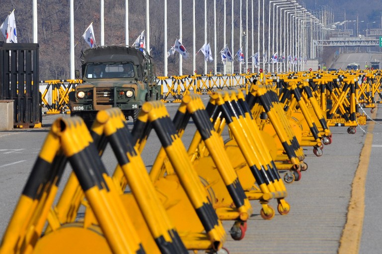 TENSE BORDER. A South Korean military vehicle drives along barricades on the road leading to North Korea at a military checkpoint in the border city of Paju on April 10, 2013. AFP PHOTO / JUNG YEON-JE