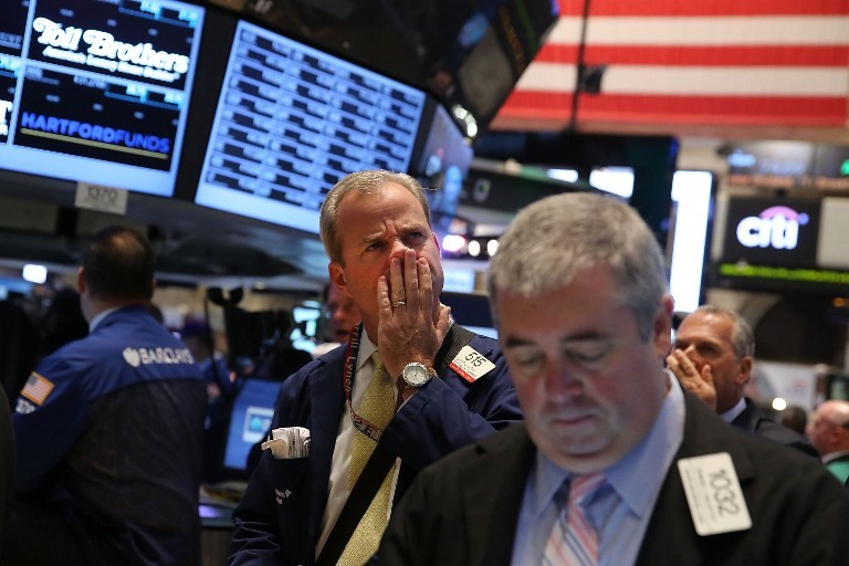 STOCKS DOWN. Traders work on the floor of the New York Stock Exchange during morning trading on September 30, 2013 in New York City. As a U.S. government shutdown looms, stocks fell sharply in the opening minutes of trading Monday. Spencer Platt/Getty Images/AFP