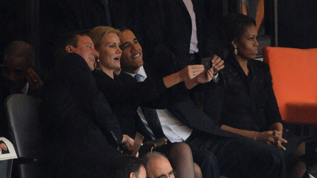 SELFIE. US President Barack Obama (R) and British Prime Minister David Cameron pose for a picture with Denmark's Prime Minister Helle Thorning Schmidt (C) next to US First Lady Michelle Obama (R) during the memorial service of South African former president Nelson Mandela at the FNB Stadium (Soccer City) in Johannesburg on December 10, 2013. Photo by Roberto Schmidt/AFP