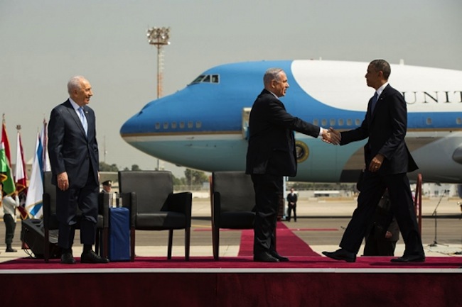 US President Barack Obama shakes hands with Israeli Prime Minister Benjamin Netanyahu during the official arrival ceremony at Ben Gurion International Airport in Tel Aviv, Israel, March 20, 2013. Israeli President Shimon Peres stands at left (Official White House Photo by Pete Souza)