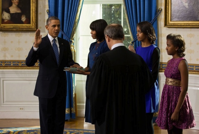US Supreme Court Chief Justice John Roberts administers the oath of office to President Barack Obama during the official swearing-in ceremony in the Blue Room of the White House on Inauguration Day, Sunday, Jan. 20, 2013. First Lady Michelle Obama, holding the Robinson family Bible, along with daughters Malia and Sasha, stand with the President. (Official White House Photo by Lawrence Jackson)