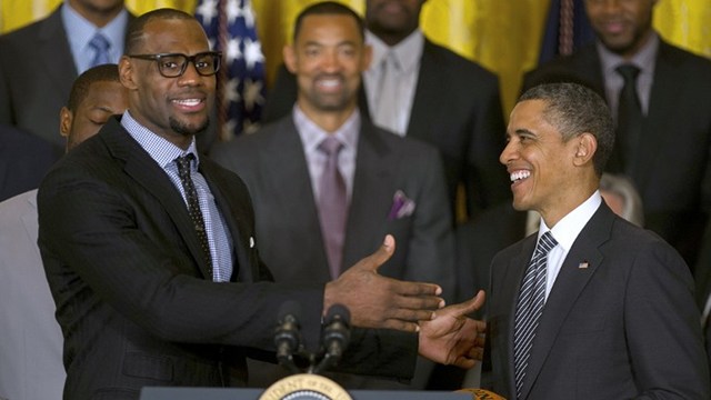 MUTUAL ADMIRATION. US President Barack Obama (R) poses with LeBron James as he welcomes the NBA Champion Miami Heat to the White House to honor the team and their 2012 NBA Championship victory at the White House in Washington, DC. AFP.