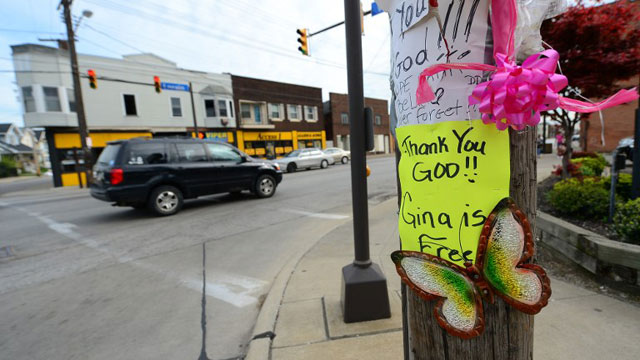 CLEVELAND, United States - Signs and balloons hang on a street pole near where Gina DeJesus was last seen a decade ago, after three women were held captive for a decade in a house, May 8, 2013 in Cleveland, ohio. Three brothers have been arrested in connection with the kidnapping of three women found safe in a home after being missing for a decade, authorities said. There were more questions than answers the day after the stunning turn of events that began with a frantic arm sticking out of a screen door, a woman screaming for help, and a neighbor kicking in the door to free her in a working-class neighborhood of the city in the American heartland. Ariel Castro and his brothers - Pedro, 54, and Onil, 50 have been detained, authorities said. AFP PHOTO/Emmanuel Dunand