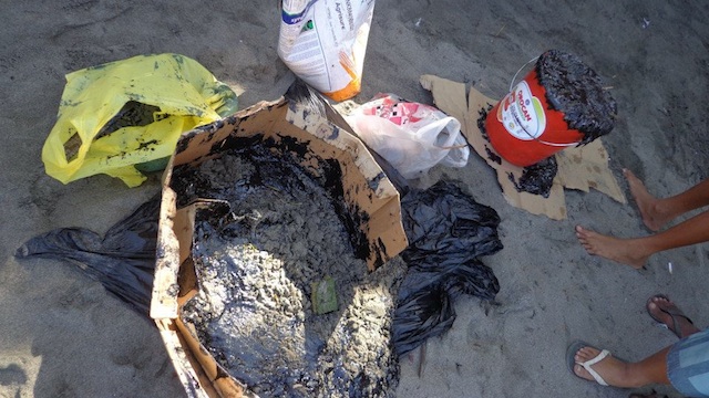 DIRTY BEACHES. Plastic bags full of residue from the oil spill in La Union