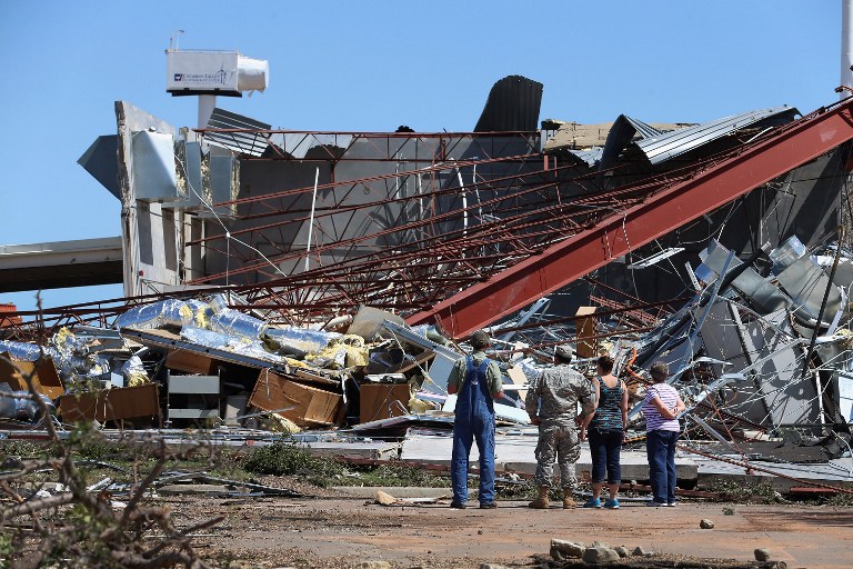 IN RUINS. People survey the damage at the at Canadian Valley Technology Center's El Reno Campus after it was hit by a powerful tornado on June 1, 2013 in El Reno, Oklahoma. Photo by Joe Raedle/Getty Images/AFP