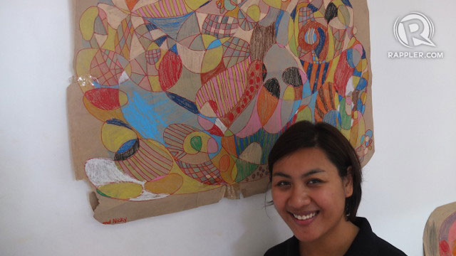 TEACHER STEPH. Stephanie Salonga poses in front of a stunning work of art by the students