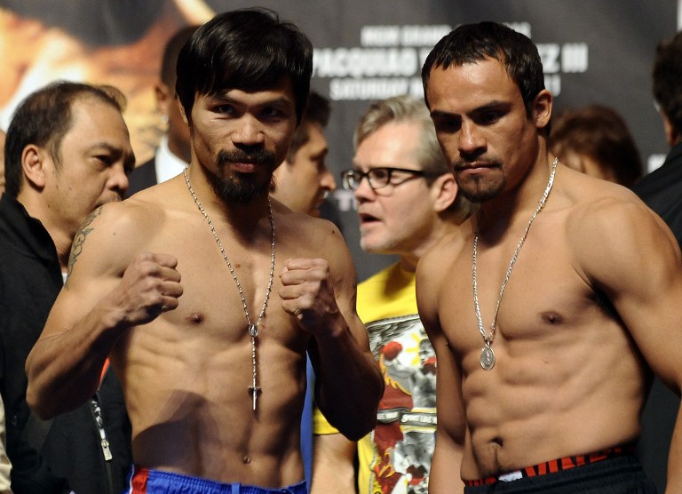 ALWAYS CLOSE. Manny Pacquiao escaped with a majority decision win over Juan Manuel Marquez in their last fight together. (AFP FILE PHOTO)