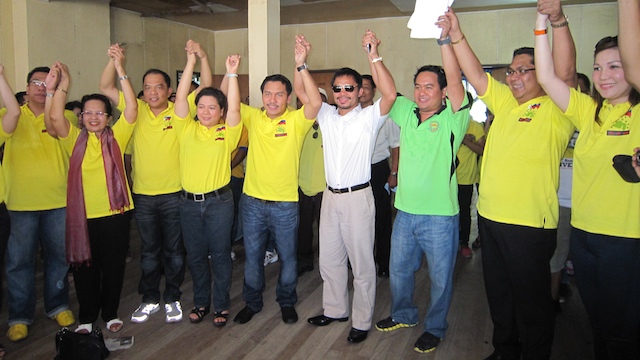 BROTHERS IN POLITICS. Sarangani Rep Manny Pacquiao (center) raises the hand of younger brother Roel Pacquiao (to his left) who is running for congressman in the 1st District of South Cotabato. Photo by Paul Bernaldez