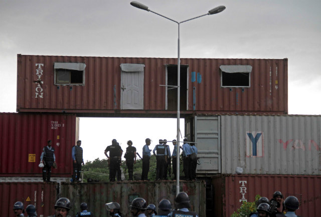 PROTEST. Pakistani Police stand guard in front of the containers to block roads to the capital Islamabad as security has been intensified ahead of the planned anti-government protest, in Islamabad, Pakistan on August 15. Photo by Sohail Shahzad/EPA