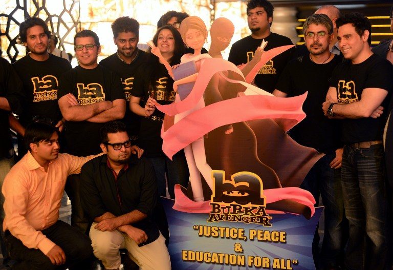 'JUSTICE, PEACE, EDUCATION' Aaron Haroon Rashid, one of Pakistan's biggest pop star (R) poses with his team at the press presentation of cartoon show Burka Avenger in Rawalpindi on August 4, 2013. Photo by AFP/Farooq Naeem