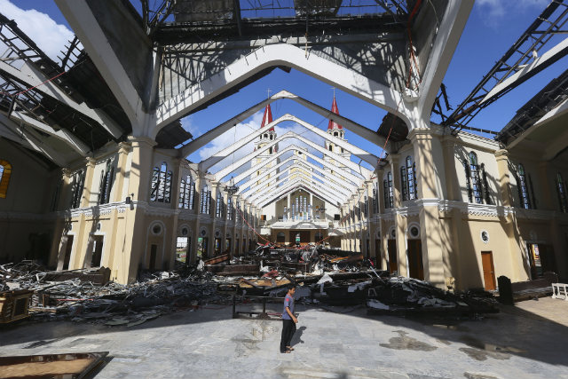 DAMAGED CATHEDRAL. A Filipino boy walks in the destroyed San Salvador Cathedral in the super typhoon devastated town of Palo, Leyte province, Philippines, November 18, 2013. Photo by Nic Bothma/EPA
