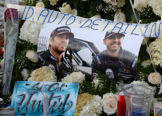 GONE BUT NOT FORGOTTEN. Candles and pictures are seen among other mementos left by fans of actor Paul Walker at a memorial rally and car cruise to remember the "Fast and Furious" star on December, 2013. AFP File Photo