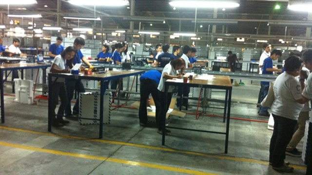 INSPECTORS. PCOS machines are being checked at Smartmatic's warehouse in Cabuyao, Laguna. Photo by Rey Santos Jr.