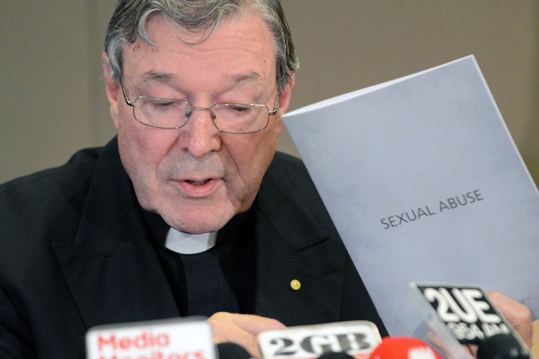 ABUSE CLAIMS. Sydney Archbishop Cardinal George Pell holds the document to the response of the archdiocese to sexual abuse during a press conference in Sydney on November 13, 2012. Photo by Roslan Rahman/AFP