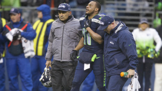 SEAHAWK DOWN. Percy Harvin is helped off the field during last week's game against the Saints. Photo by Stephen Brashear/EPA