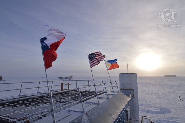 PHILIPPINE FLAG AT THE SOUTH POLE. A Philippine flag (R) flutters in the strong Antarctic winds, along with American (C) and Chilean (L) flags atop the IceCube observatory, Amundsen-Scott South Pole Station, Antarctica. Photo by Blaise Kuo Tiong