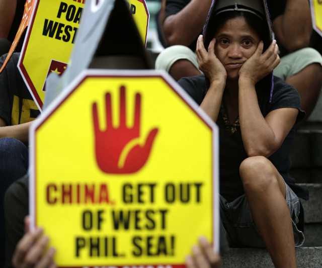 PROTEST VS CHINA. A Filipino protester holds a placard during a rally outside the Chinese consulate in Makati City on June 11, a day before the 115th anniversary of the country's independence. File photo by EPA/Dennis M Sabangan