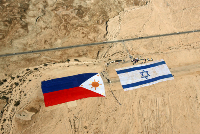 STRONG TIES. An aerial view of giant Israel (right) and Philippine (left) flags after they were unrolled on an airport runway in the desert near the Dead Sea on Nov 25, 2007. File photo by Jim Hollander/EPA
