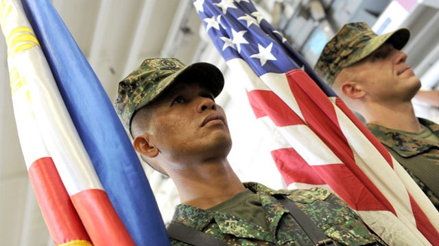 SIDE BY SIDE. US and Philippine Marines carry their respective colors at the formal opening of the annual Philippine-US Amphibious Landing Exercises aboard the USS Bonhomme Richard which docked at the former US naval base of Subic on October 8, 2012. Photo by AFP/Jay Directo