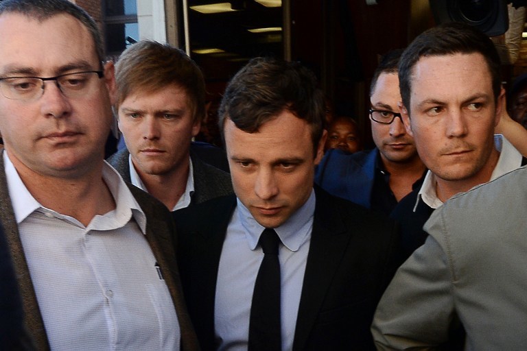FACING TRIAL. South African Olympic sprinter Oscar Pistorius (C) leaves the Magistrate Court in Pretoria on August 19, 2013. Pistorius will go trial in March charged with murdering his girlfriend on Valentine's Day, a magistrate ruled at a packed court hearing on August 19, 2013. Photo by AFP/Alexander Joe
